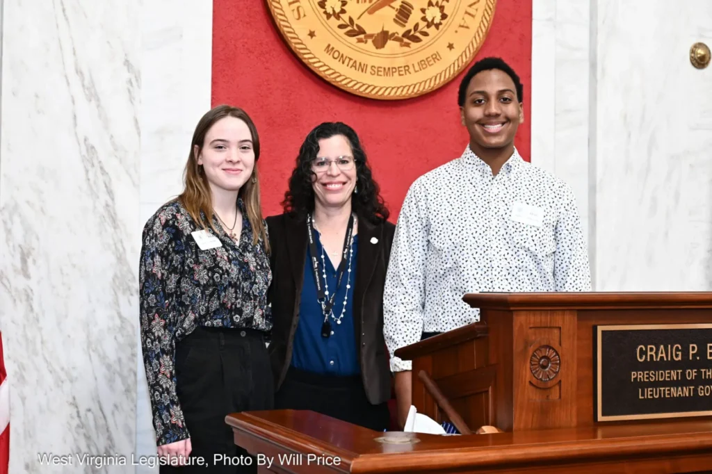 director and students smiling